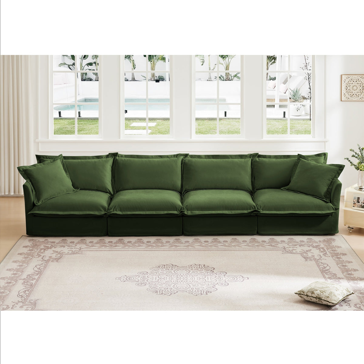 Green slipcovered four-seat sofa in a sunlit room