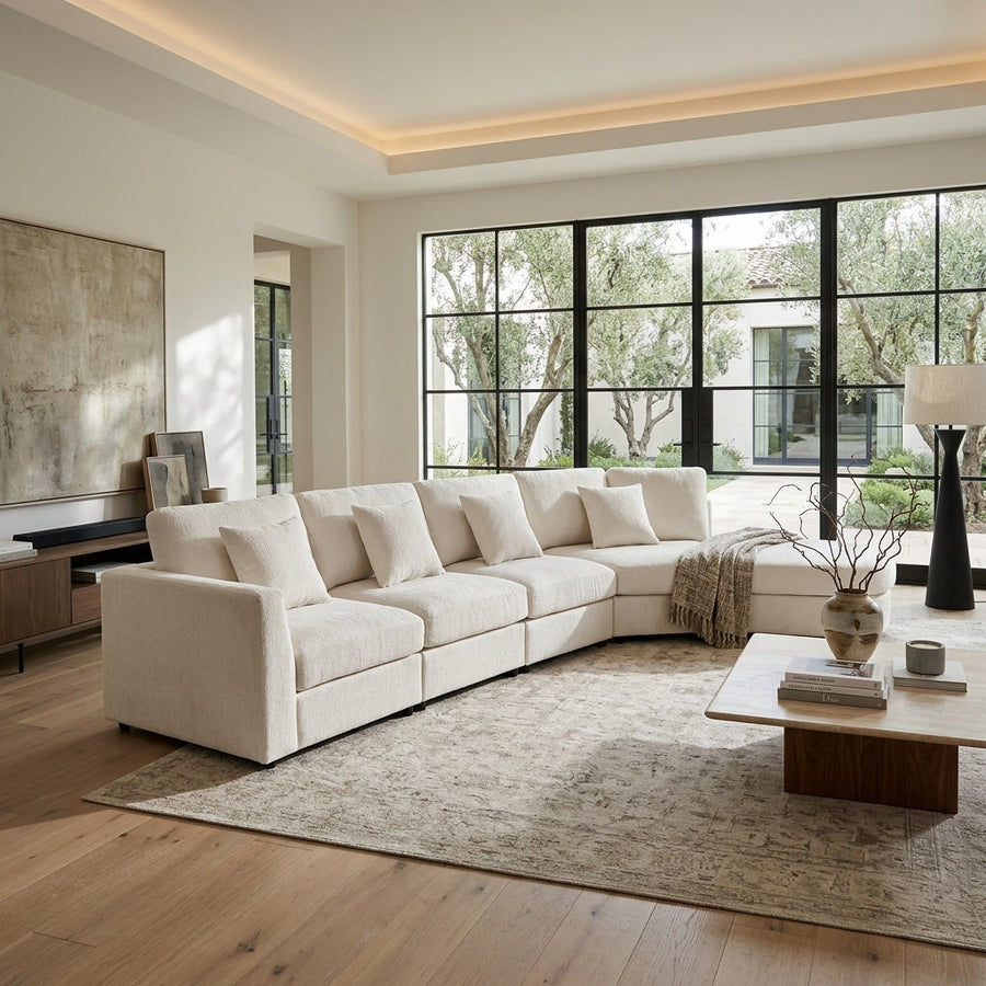 Cream curved modular sectional sofa in a bright living room