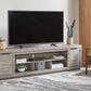 Naydell - XL TV Stand w/Fireplace Option - Gray