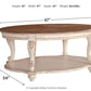 Realyn - Oval Cocktail Table - White / Brown