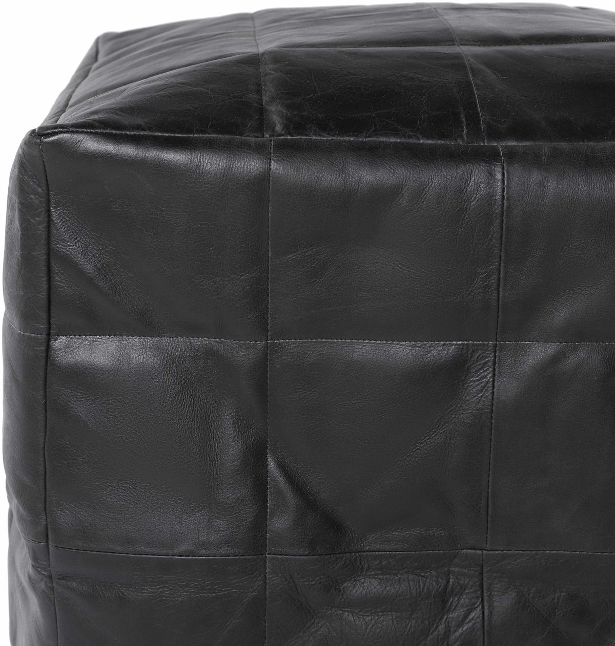 Close merchant photograph of the stitched leather top of the Laflin pouf